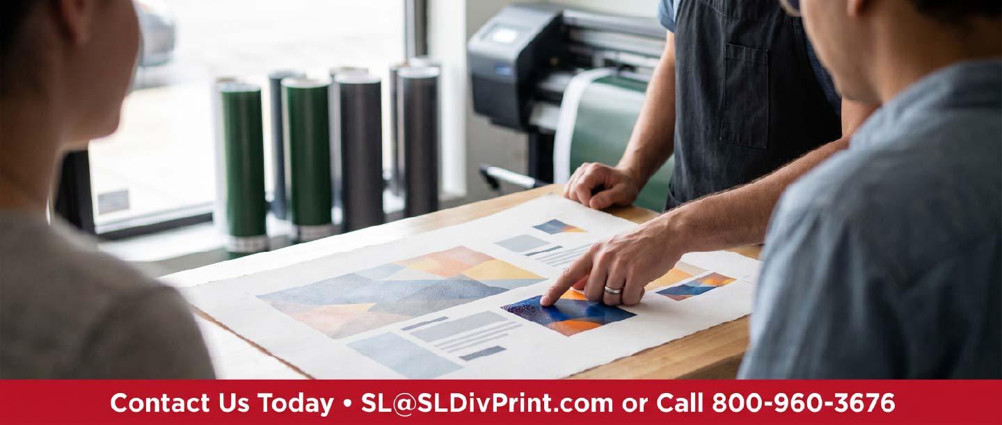 Print professional and client reviewing a printed proof sheet together at a boutique print shop counter demonstrating human proofing support. rush printing service, same day order turnaround, boutique print shop, 48 hour embroidery, trade show banner deadline, custom check vendor, human proofing support, guaranteed delivery date, Scottsdale promotional products, nationwide fulfillment partner, screen printed apparel