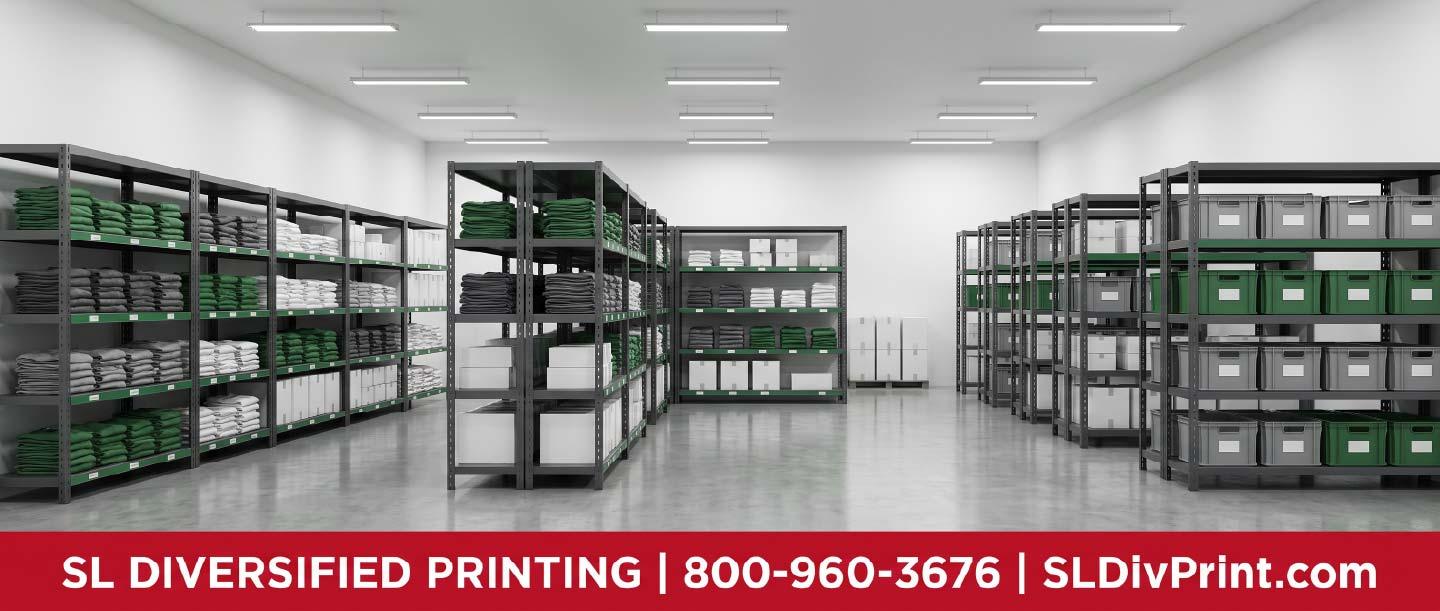 Organized warehouse aisle with labeled shelving holding folded branded apparel and boxed promotional products employee swag fulfillment remote team merch branded merchandise fulfillment merch warehousing company store kitting Arizona distribution hub onboarding kit shipping international merch delivery promotional product storage