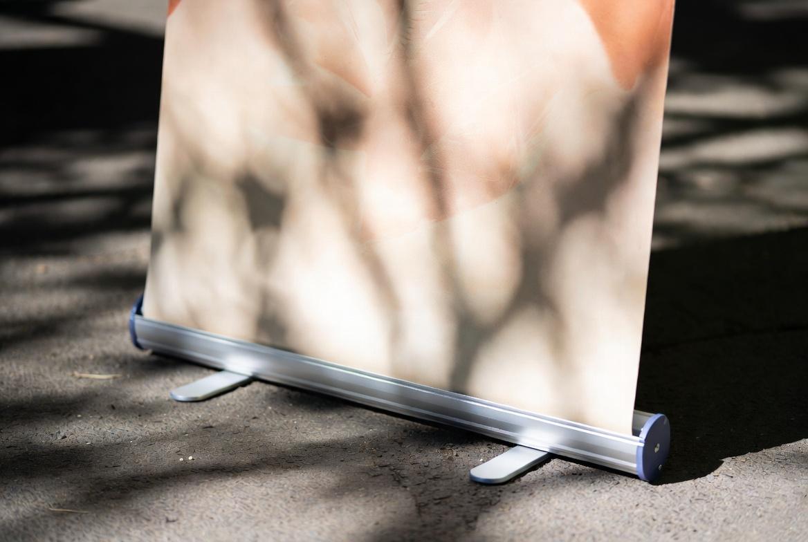 CloseUp of Premium Retractable Banner Printing | SL Diversified Printing close up of 33x80 retractable banner rolling out showing premium vinyl and stay flat technology