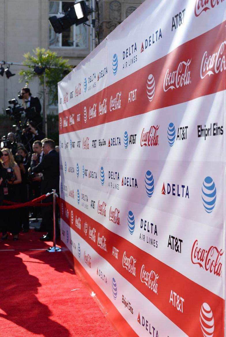 retractable step repeat banner at red carpet event with custom sponsor logos for brand visibility